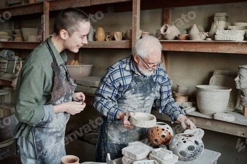 Preview: People sculpting ceramic vases in workshop