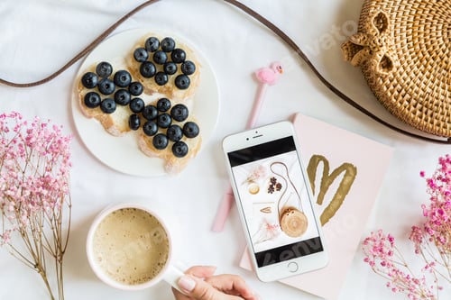 Preview: Flatlay items: woman’s hand holding cup of coffee
