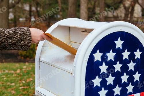 Preview: Close-up Of Postman Putting Letters Mailbox American flag