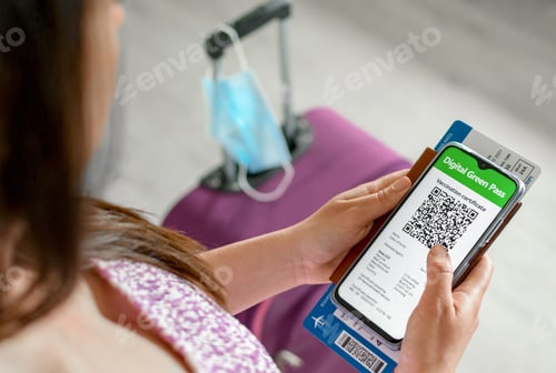 Preview: Top view of woman holding identification documents vaccine certificate on smartphone at airport.