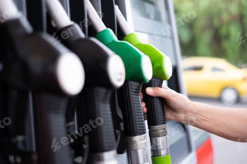 Preview: Woman at self service fuel pump in european gas station - inflation, rising prices, economy