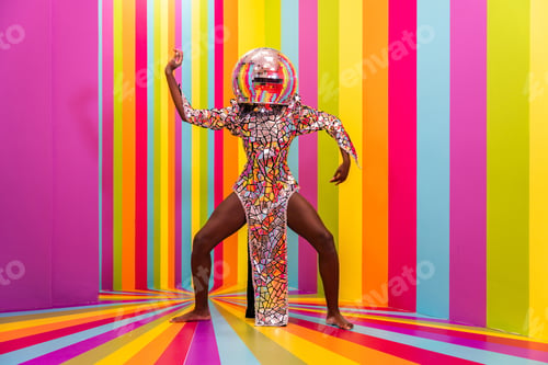 Preview: Beautiful young woman dancing and having fun inside a rainbow box room