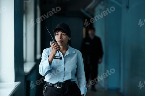 Preview: Female guard speaking on walkie-talkie
