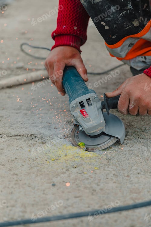 Preview: Worker's Hands Operating Concrete Cutter at Construction Site