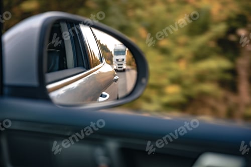 Preview: The view of the road in the car's rearview mirror.