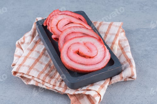 Preview: Fried bacons in black wooden plate on grey background