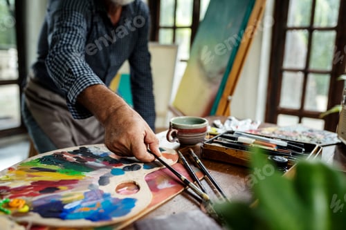 Preview: Artist painting artwork at workspace