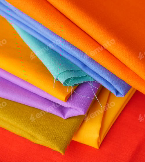 Preview: Stack of Colorful Cotton Fabrics Close Up