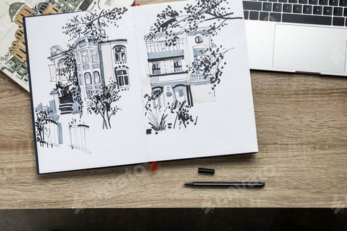 Preview: top view of drawings in albums and laptop on wooden background