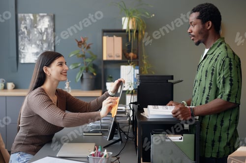 Preview: Two Smiling Colleagues Opposite Each Other at Office