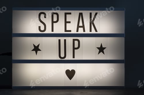 Preview: Speak up signage with stars and a heart on an illuminated whiteboard