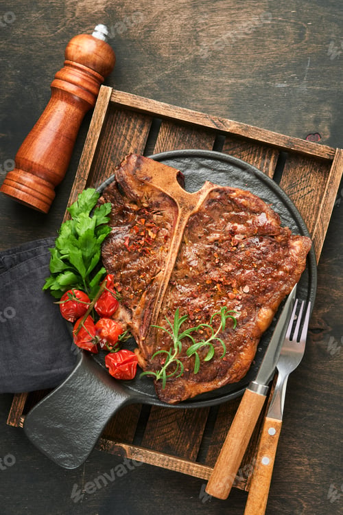 Preview: Steaks T-bone. Sliced beef grilled T-bone or porterhouse meat steak with spices rosemary and pepper