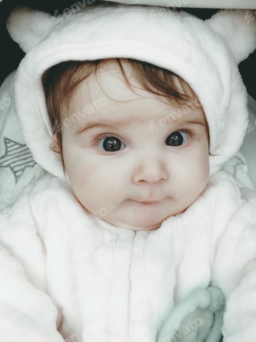 Preview: Lovely portrait of a baby girl wearing winter clothes