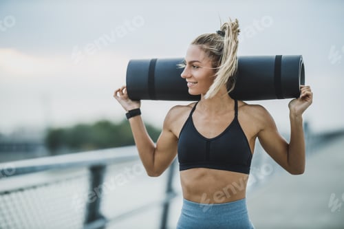 Preview: Woman Holding Rolled Up Exercise Mat And Preparing For Outdoor Training
