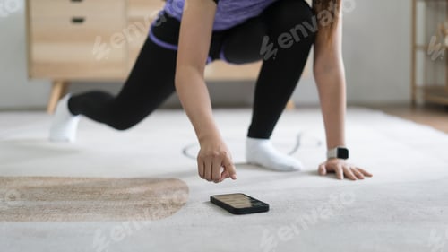 Preview: Young asian woman checking workout time on smartphone while doing exercise with healthy lifestyle