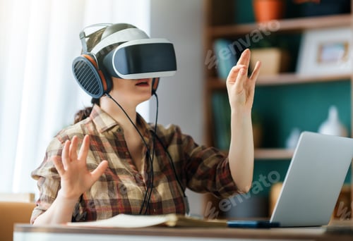 Preview: Woman Using VR Headset in Home Office with Laptop