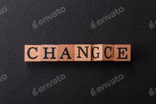 Preview: The inscription chance or change with wooden cubes on a dark concrete background