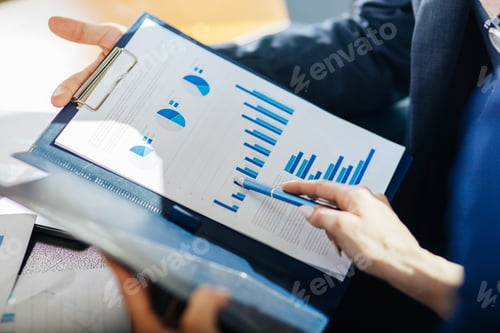 Preview: Close up of woman hand pointing at business document during discussion at meeting