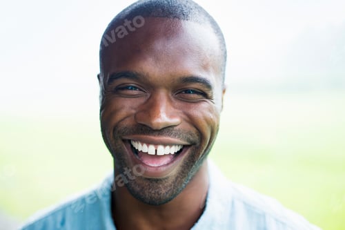 Preview: A young man in a blue shirt, laughing.