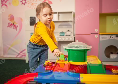 Preview: Young Girl Playing with Toy Cars at Home
