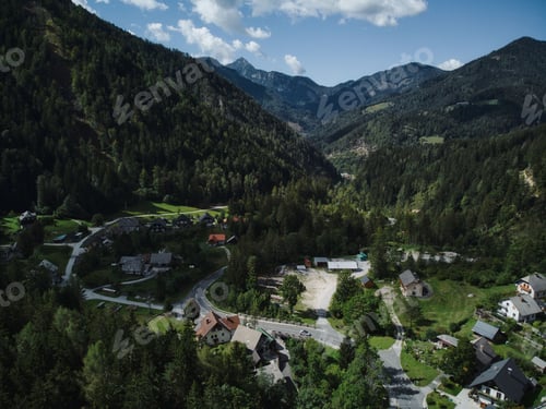 Preview: Beautiful view from a drone of a village with curly road surrounded by mountains in Slovenia