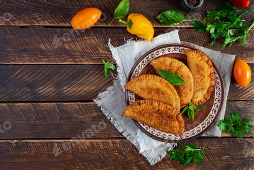 Preview: Traditional Crimean Tatar cuisine, chebureki with chicken meat. Fried empanadas on wooden background