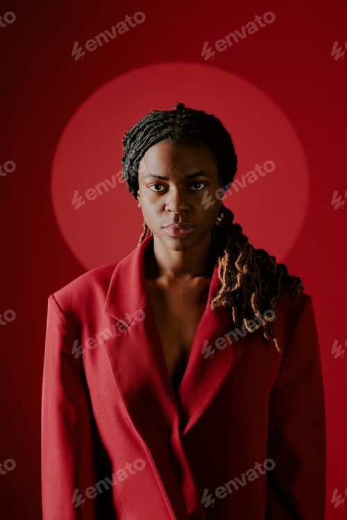 Preview: Portrait of Woman Wearing Red Blazer Against Red Background