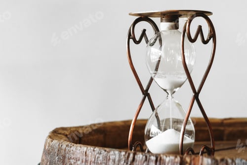 Preview: Sandglass on wooden bakground closeup. Time concept