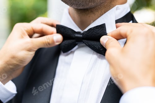 Preview: Man Adjusting Bowtie Before Special Event