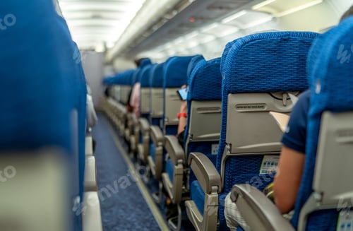 Preview: Selective focus on sign fasten seat belt while seated and blurred of passenger reading book
