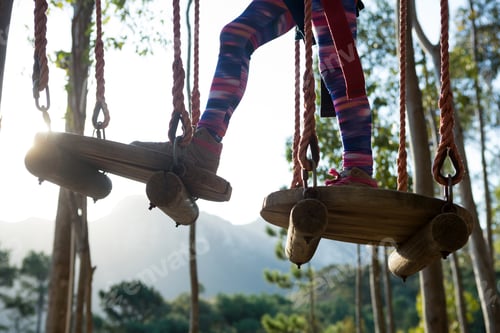 Preview: Little girl feet crossing obstacle in forest on a sunny day