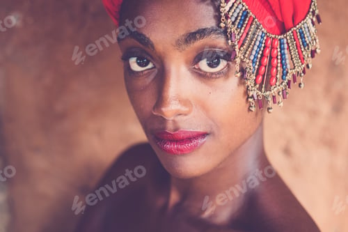 Preview: Beauty and beautiful black african girl with traditional fashion hat with jewels posing and looking