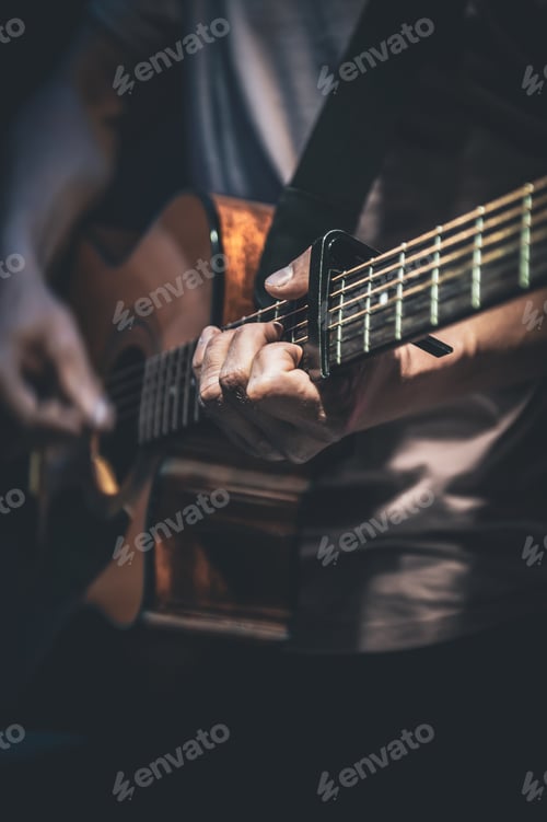 Preview: A man plays an acoustic guitar, close-up.