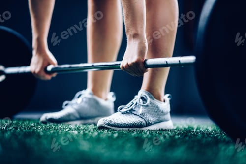 Preview: Girl picking up long barbell with to do deadlift