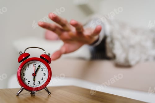 Preview: Red old style clock with sleeping man on background
