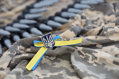 Preview: Ukrainian symbol and a machine gun belt on the camouflage uniform of a Ukrainian soldier