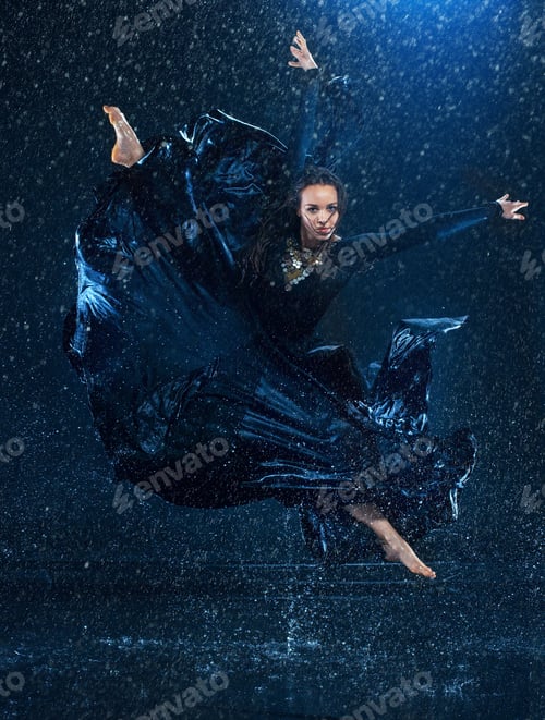 Preview: The young beautiful modern dancer dancing under water drops