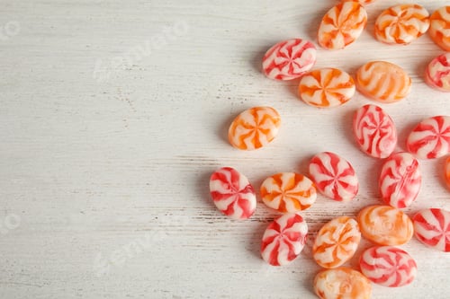 Preview: Flat lay composition with delicious colorful candies and space for text on wooden background