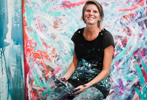 Preview: Senior woman painting inside her atelier studio at home