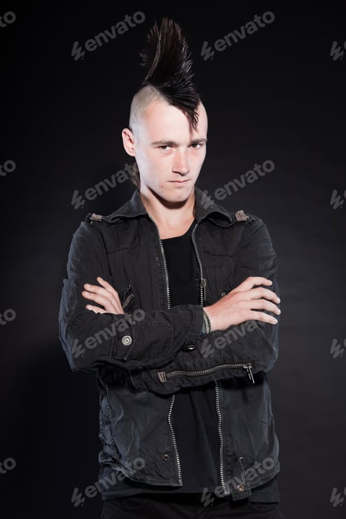 Preview: Punk Man With Mohawk Haircut. Expressive Face. Grey Jacket. Isolated On Black Background. Studio