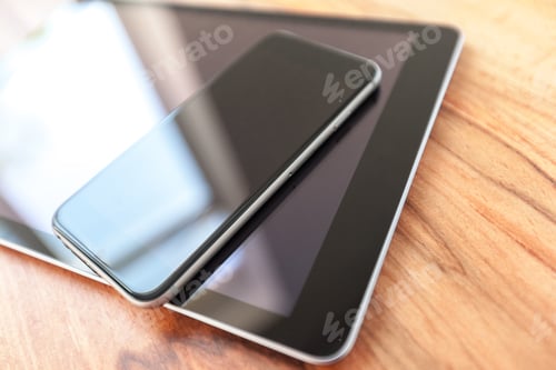 Preview: digital tablet and smart phone on wooden table