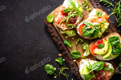 Preview: Open sandwich set with cream cheese, prosciutto, salmon, avocado and fresh greens.