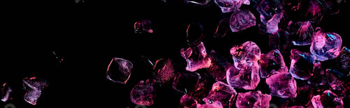 Preview: panoramic shot of transparent ice cubes with purple light isolated on black