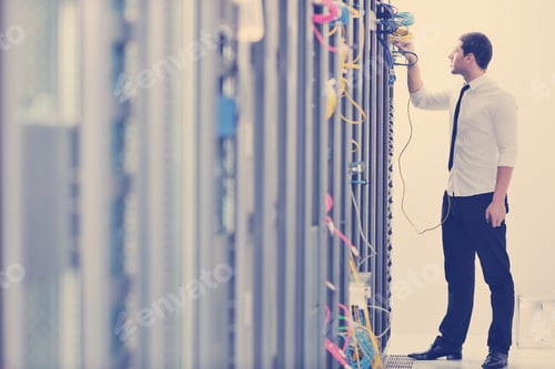 Preview: young engeneer in datacenter server room