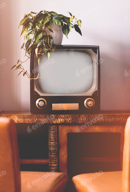 Preview: Old vintage retro TV in living room with two chairs and a houseplant