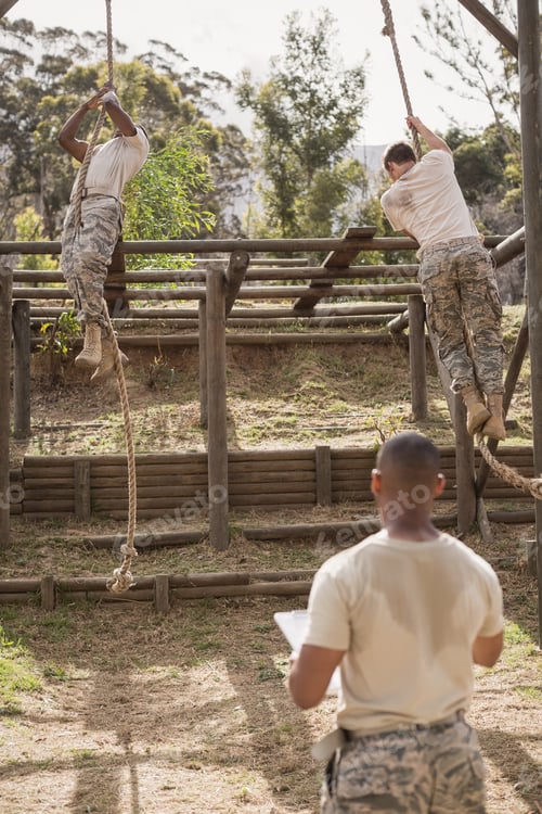 Preview: Military soldiers climbing rope during obstacle course training