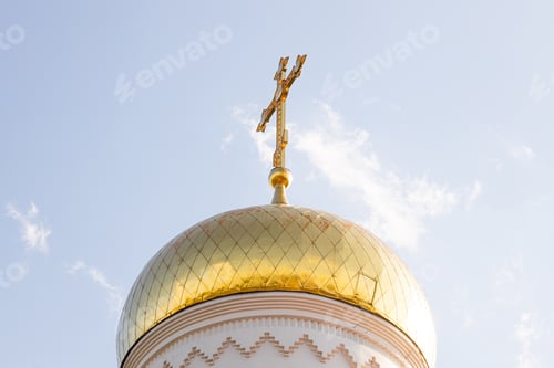 Preview: Bottom view of shiny sunlit christian church dome with cross on top