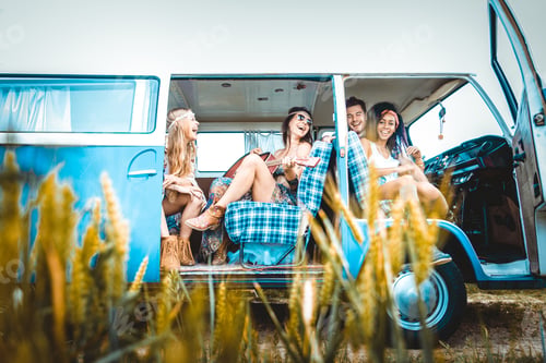 Preview: Happy friends driving a vintage minivan
