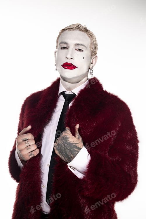 Preview: Young man showcases stunning Joker costume for Halloween celebration in stylish setting
