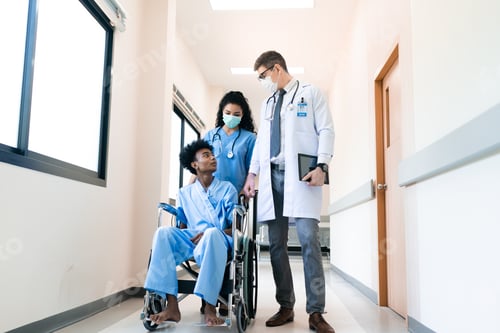 Preview: Caucasian male doctor, nurse and patient on wheelchair discussing or having a conversation